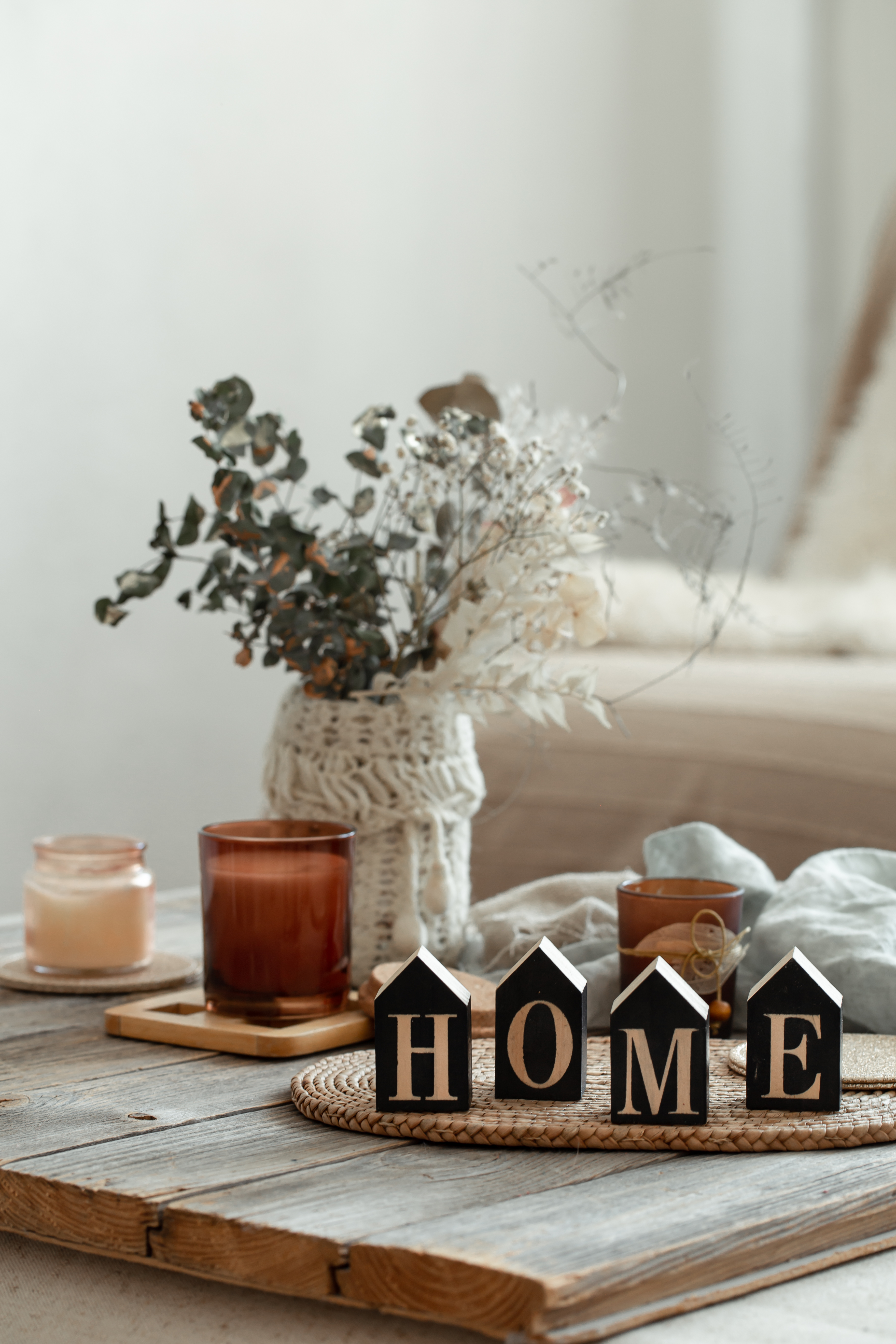 Close up decorative word home on blurred background with candles.